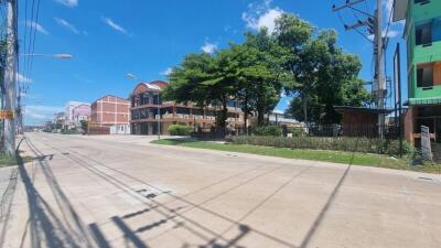 Street view of neighborhood with buildings and greenery