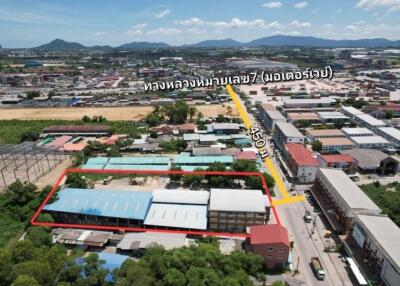 Aerial view of buildings and surrounding area with road direction