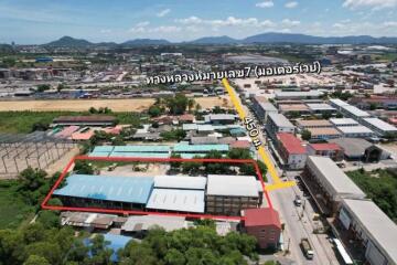 Aerial view of buildings and surrounding area with road direction