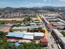 Aerial view of buildings and surrounding area with road direction