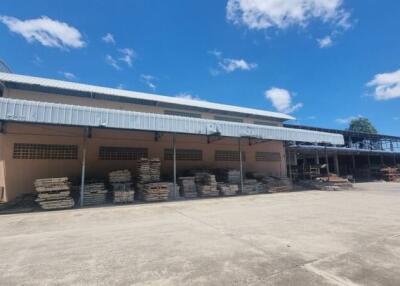 Outdoor view of an industrial building with a concrete yard