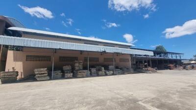 Outdoor view of an industrial building with a concrete yard