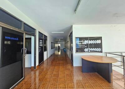 Hallway with office doors and a table