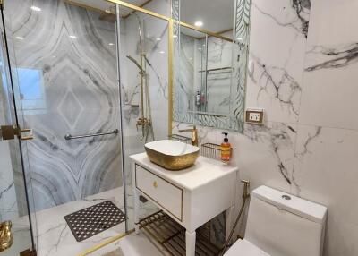 Luxurious bathroom with marble walls and modern fixtures