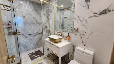 Luxurious bathroom with marble walls and modern fixtures
