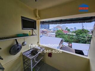 Small kitchen area with a sink and city view