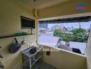 Small kitchen area with a sink and city view