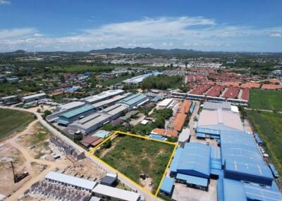 Aerial view of an industrial area with buildings and green spaces