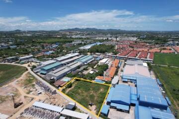 Aerial view of an industrial area with buildings and green spaces