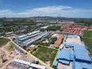 Aerial view of an industrial area with buildings and green spaces