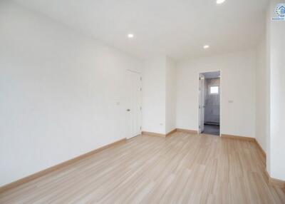 Spacious empty room with wooden flooring