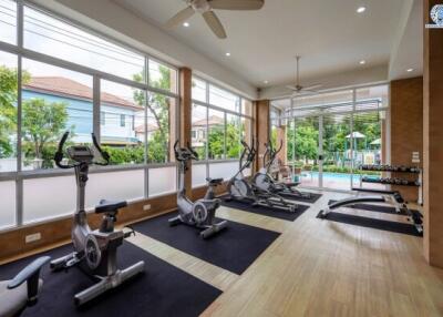 Spacious home gym with exercise equipment and large windows
