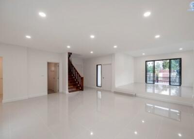 Spacious living area with glossy flooring and large windows