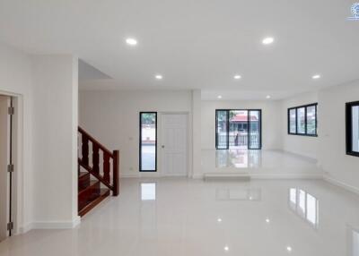 spacious living room with modern lighting and large windows