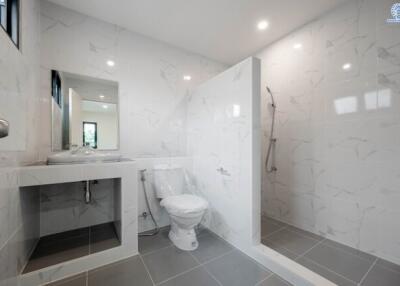 Modern bathroom with marble tile walls and a walk-in shower