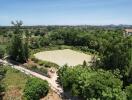 Aerial view of a green landscape with a pond