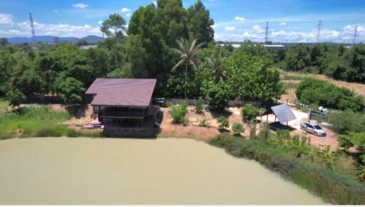 Exterior view of property by a lake with surrounding greenery