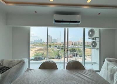 Spacious living room with large windows and city view