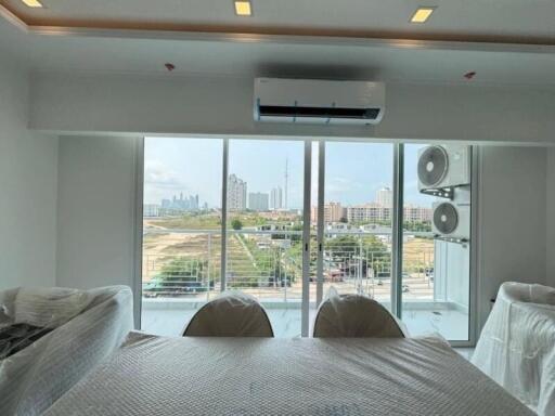 Spacious living room with large windows and city view