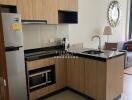 Modern kitchen with wooden cabinets and black countertops