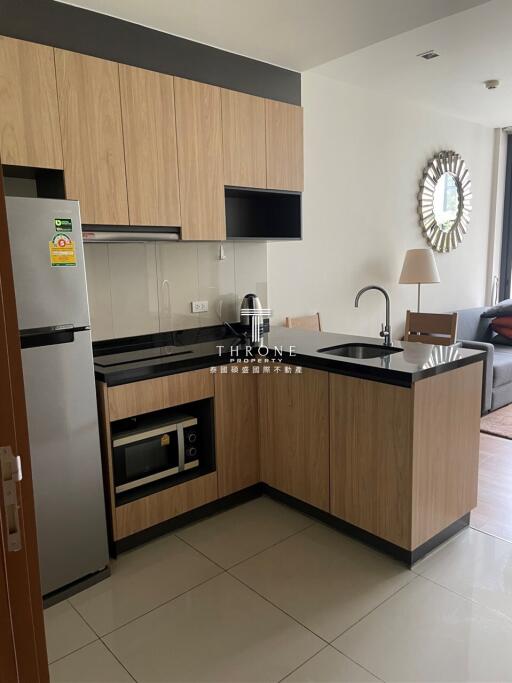 Modern kitchen with wooden cabinets and black countertops