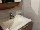 Modern bathroom sink with wooden cabinet