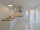 Modern kitchen with white cabinets and wooden countertop