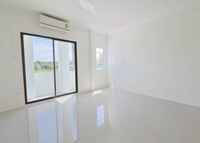 Bright living room with sliding glass door and window