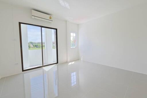 Bright living room with sliding glass door and window