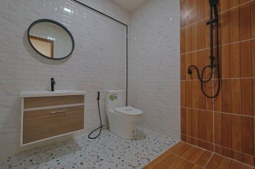 Modern bathroom with tiled walls and shower area