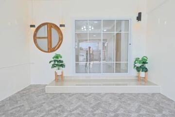 Bright living room with large window and decorative elements