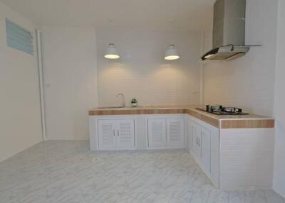 modern kitchen with white cabinetry and gas stove