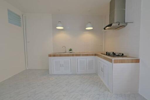 modern kitchen with white cabinetry and gas stove