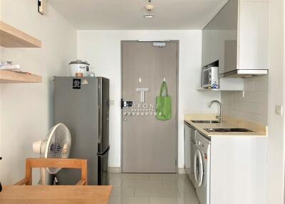 Modern kitchen with stainless steel appliances and wooden shelves