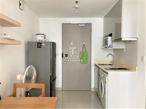 Modern kitchen with stainless steel appliances and wooden shelves