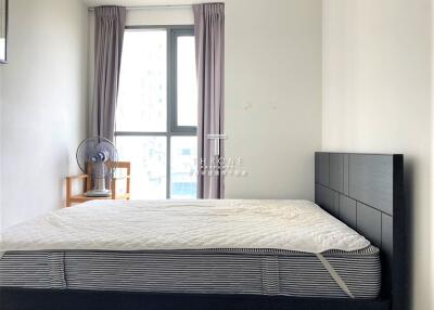 Bedroom with large window and simple furnishings