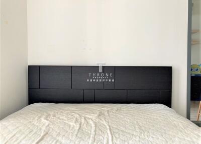 Modern bedroom with a bed featuring a black headboard
