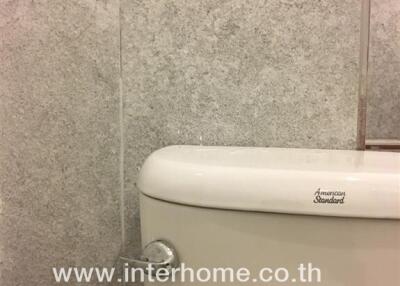 Bathroom with tiled wall and toilet