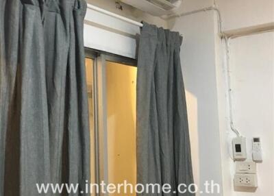 Room with air conditioner and grey curtains