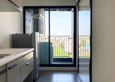 Modern kitchen with appliances and a balcony view