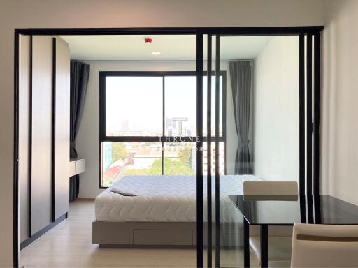 Modern bedroom with glass sliding doors and city view