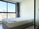 Modern bedroom with large window and city view