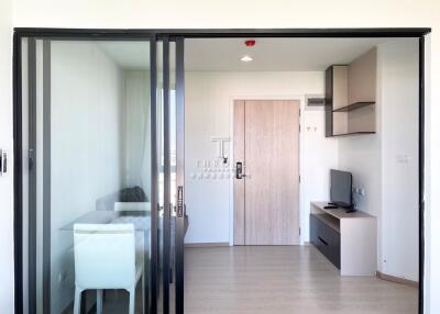 Modern living area with sliding glass door and wooden furnishings