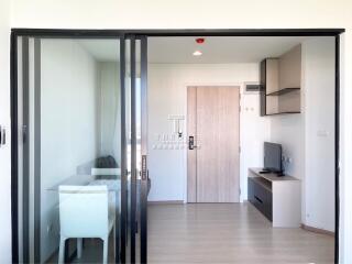 Modern living area with sliding glass door and wooden furnishings