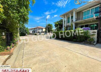 Spacious residential street with modern houses and lush greenery