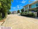 Spacious residential street with modern houses and lush greenery