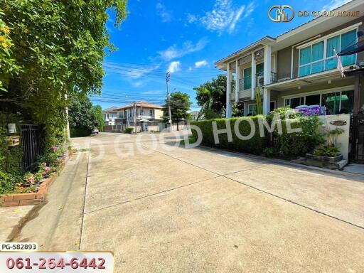 Spacious residential street with modern houses and lush greenery