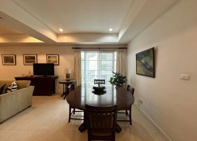 Living room with dining area, round table, and chairs