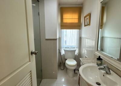 Modern bathroom with a shower, toilet, and sink