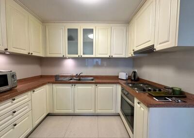 Modern kitchen with white cabinets and stainless steel appliances